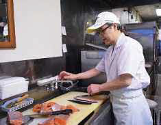 写真：魚をさばく中村さん